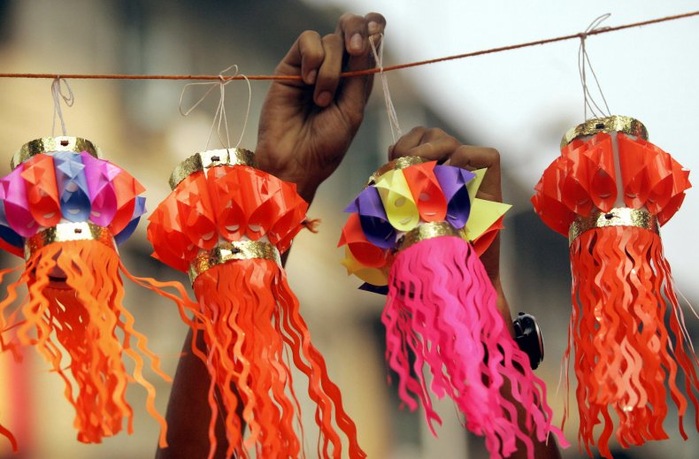 7 Diwali decorations to celebrate the 'Festival of Lights' in style 3 Person hangs paper lanterns during Diwali