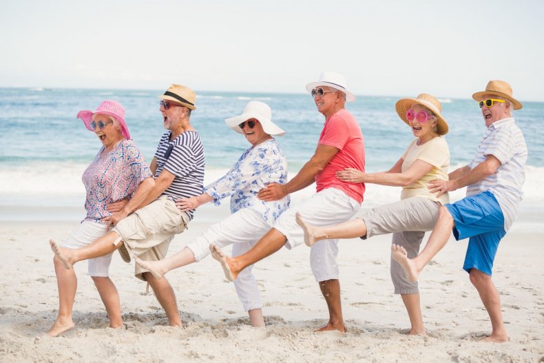 old-people-conga-dance-beach-stock