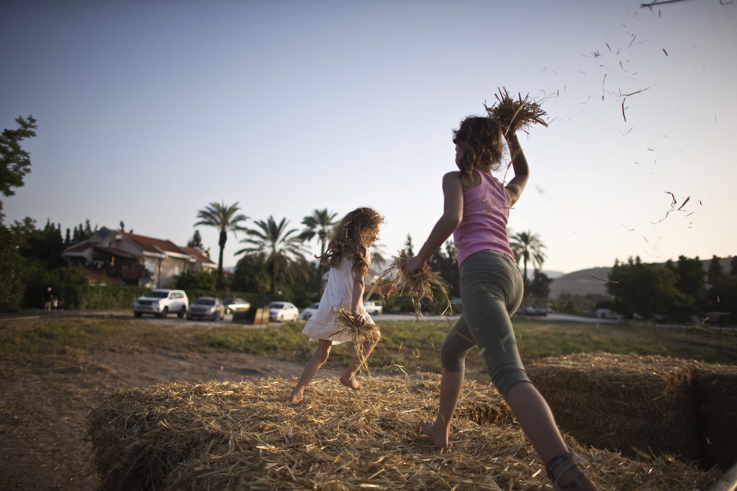 Girls playing in hay