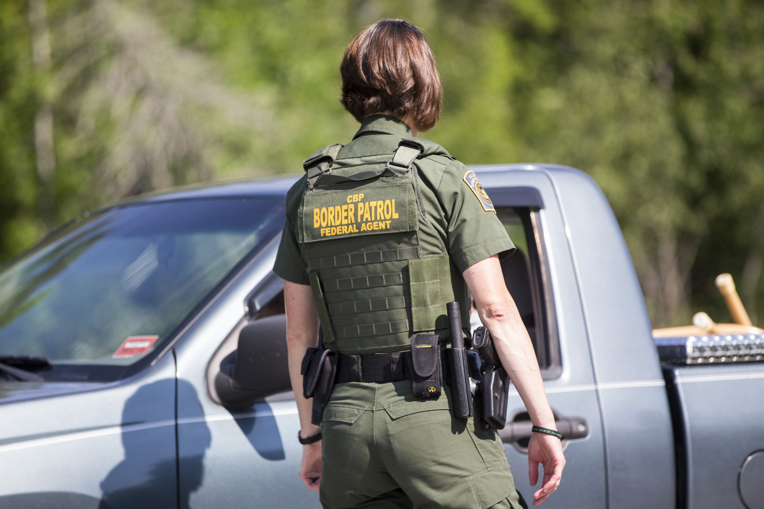 A U.S. Border Patrol agent questions a driver at a highway checkpoint in We...