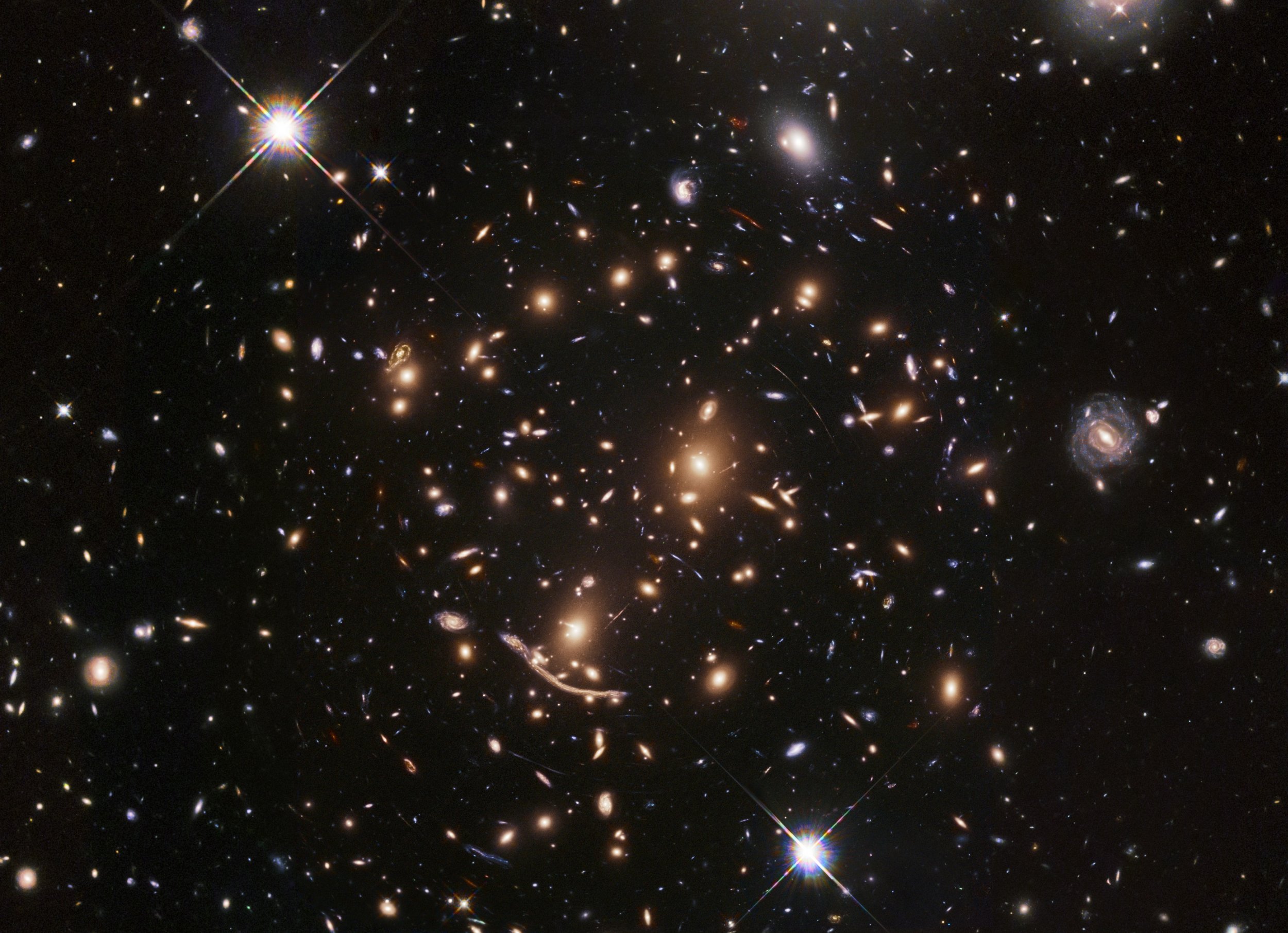 Hubble Space Telescope looks into center of vast galaxy cluster almost 9  billion light-years away