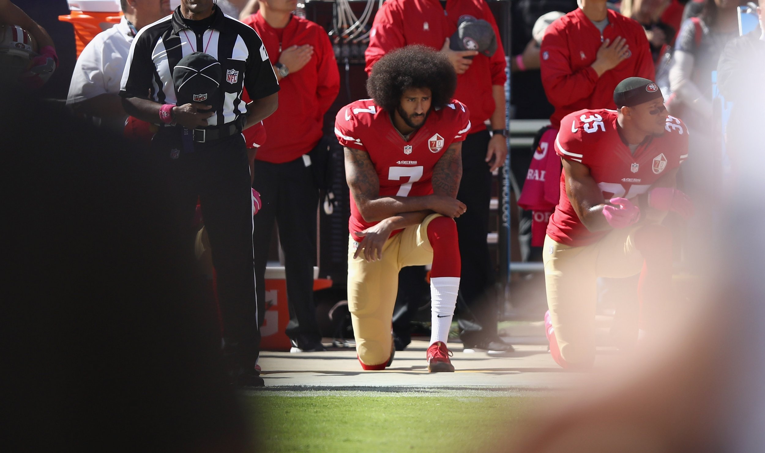 San Francisco 49ers cheerleader takes a knee during national anthem