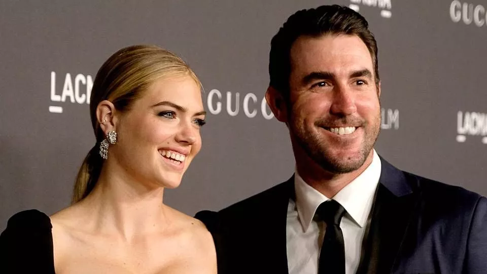 A color, born digital image of Justin Verlander #35 of the Houston Astros  smiling for a photo with his fiancé, American model and actress Kate Upton,  and the game worn jersey that