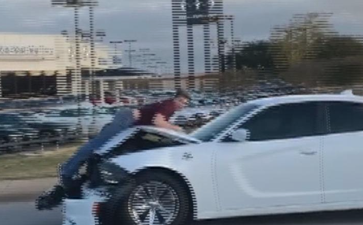 Man Rides On Car Hood