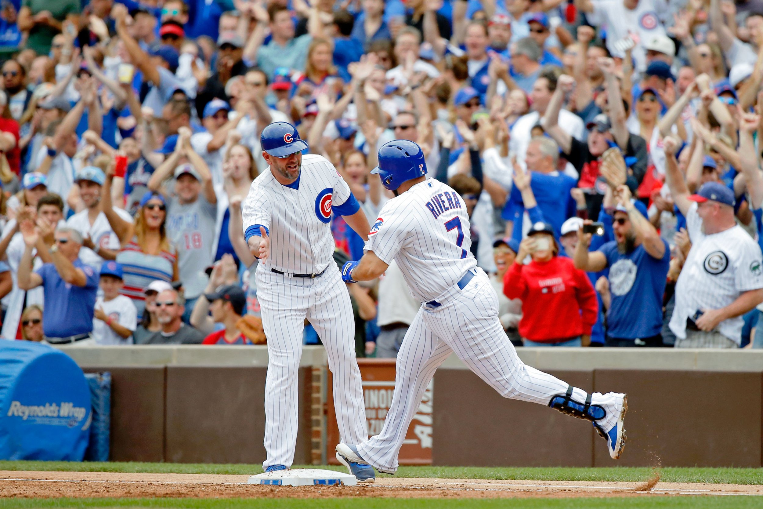 Chicago Cubs' Jon Jay asks first base coach Brandon Hyde if his