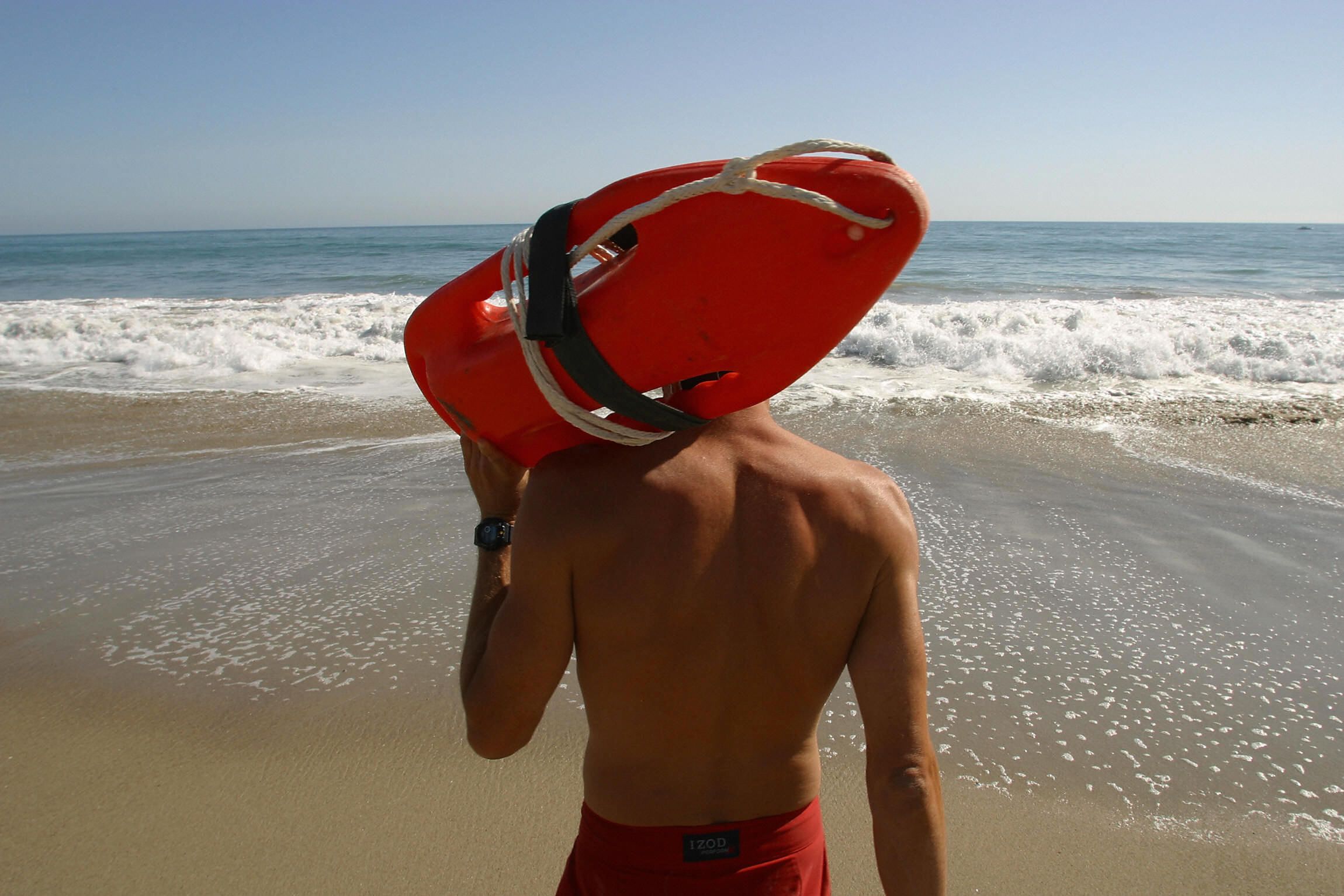 Dramatic Viral Images Show Lifeguard Rescue Surfer in Treacherous