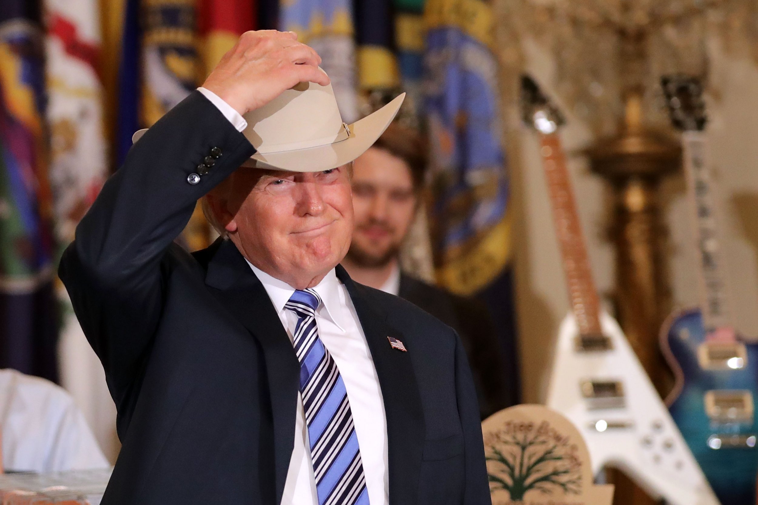 President Donald Trump puts on a Stetson cowboy hat while touring a Made in...