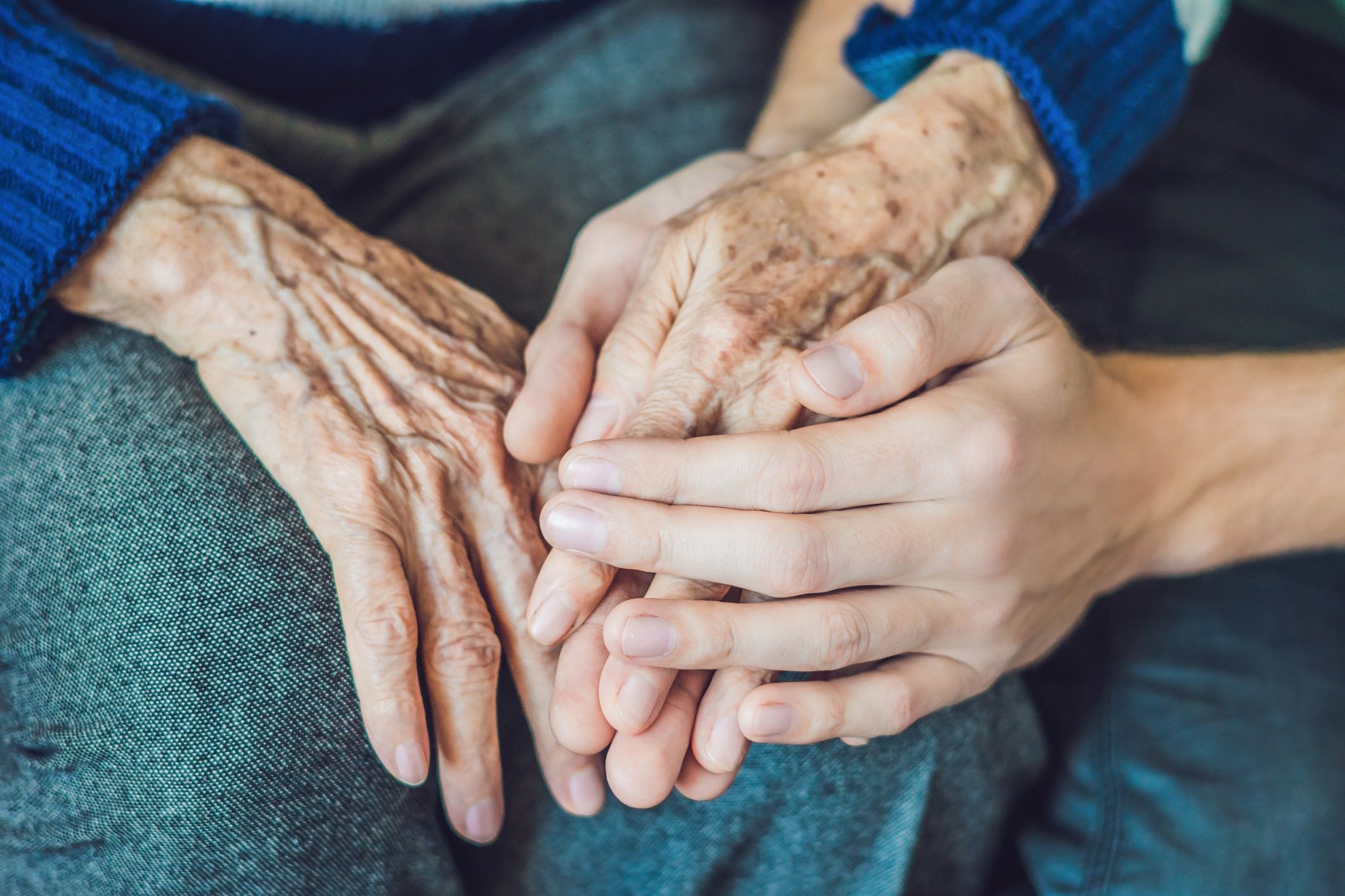 old young holding hands stock getty