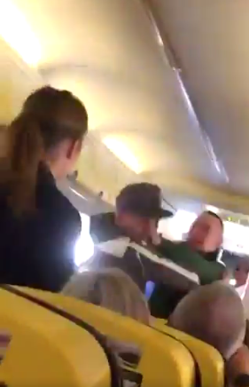 squeed between 2 passenger in a plane