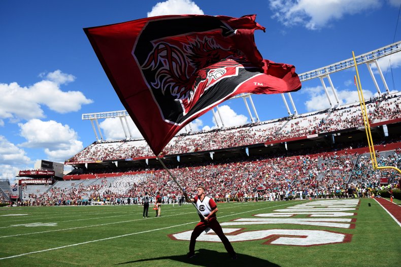 A cheerleader of the South Carolina Gamecocks waves a flag during their gam...