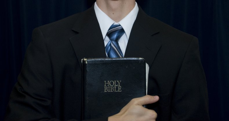 pastor holding bible stock photo