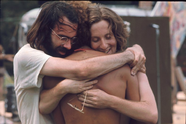 Three men hugging Woodstock 