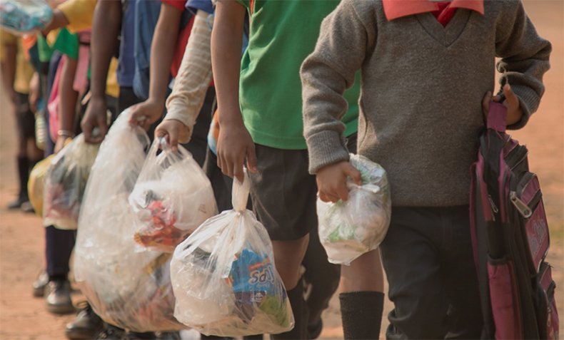 Children carry plastic waste to school Children carry plastic waste to school