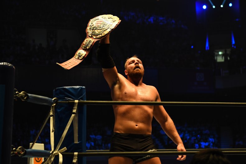 Jon Moxley lifts the belt