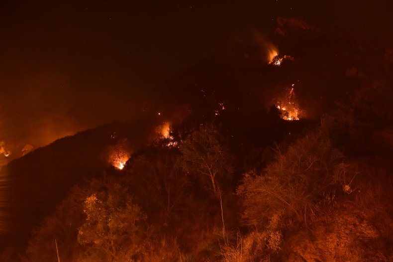 Spot fires burn on the hills above Pepperdine University during the Woolsey fire, November 12, 2018 in Malibu, California.