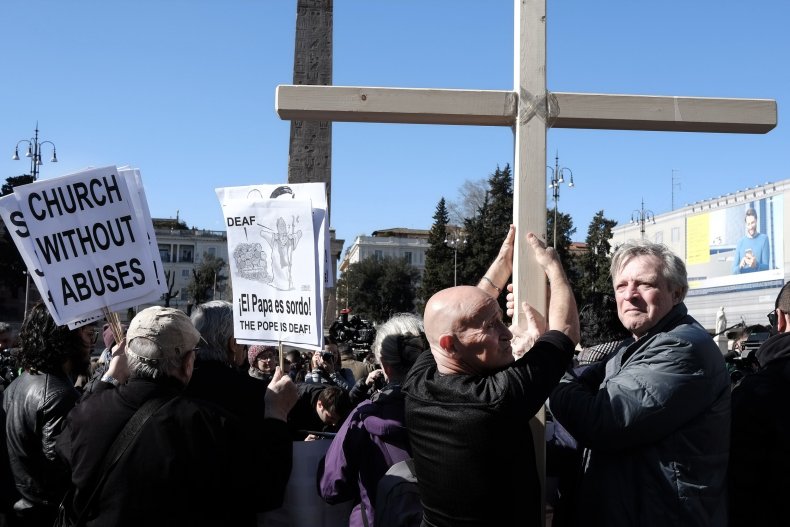 Protesters holding sign and cross