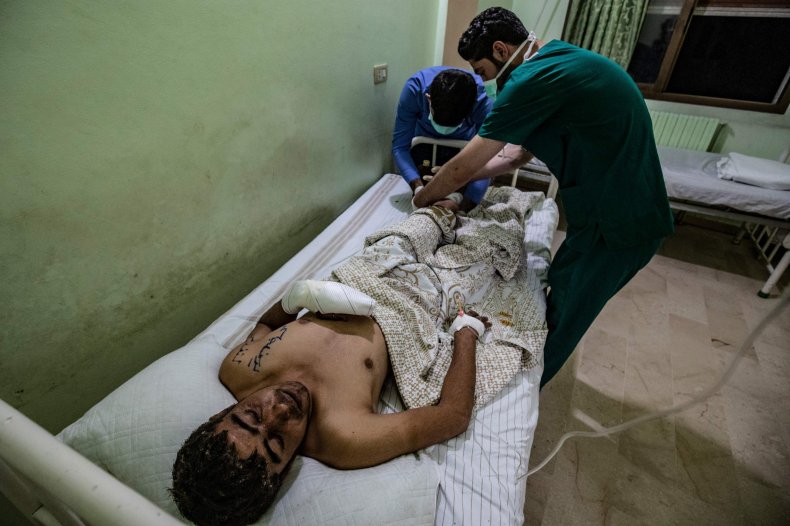 A wounded man receives treatment