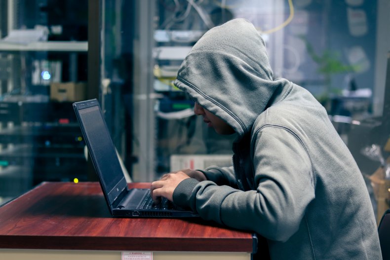 Young hacker using laptop
