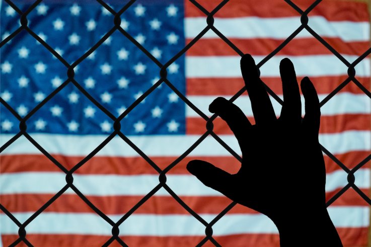 usa flag behind fence usa flag behind fence