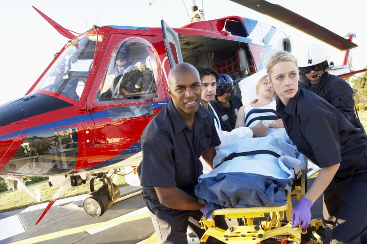 Paramedics unloading patient from helicopter Paramedics unloading patient from helicopter