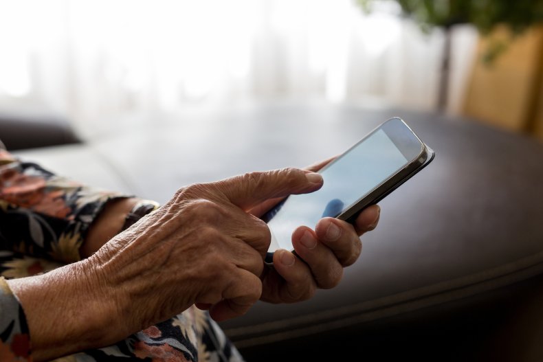 Elderly hands holding cell phone