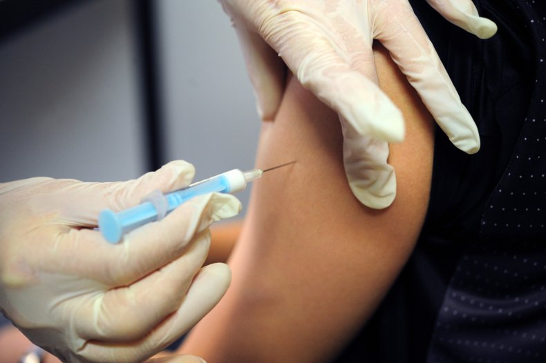 A pupil receives flu vaccine
