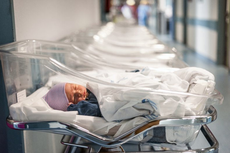 Newborn baby in hospital bed