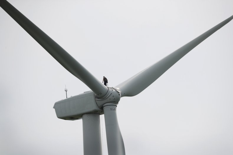worker repairs a power generating windmill