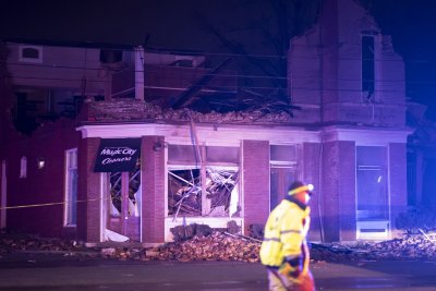 Emergency crews work near a damaged business Emergency crews work near a damaged business
