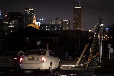 Cars stop at service lines downed by a tornado Cars stop at service lines downed by a tornado