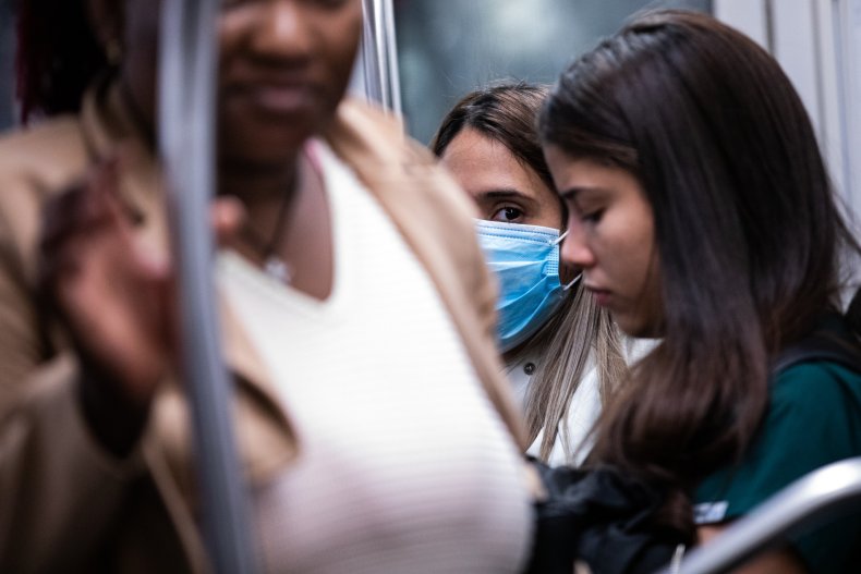 Woman rides subway mask