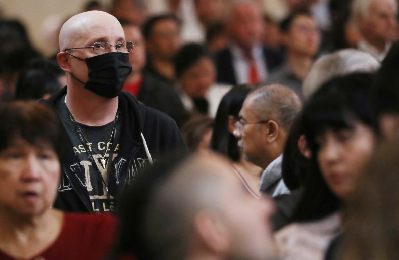 Worshipper at cathedral in LA wearing mask