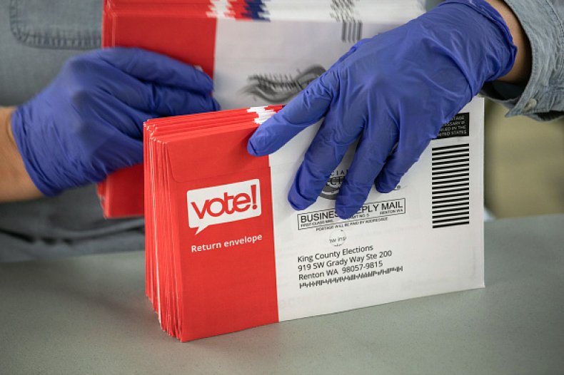 election worker wears gloves due to coronavirus