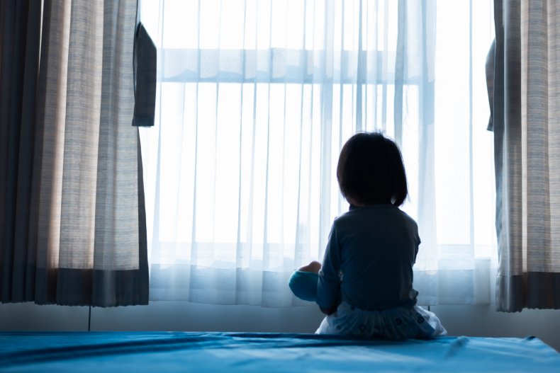Child sitting with doll