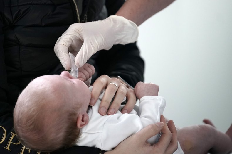 Doctor gives baby medicine