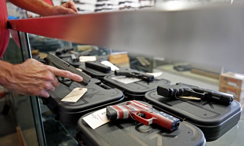 A Worker Restocks Gandguns in Utah