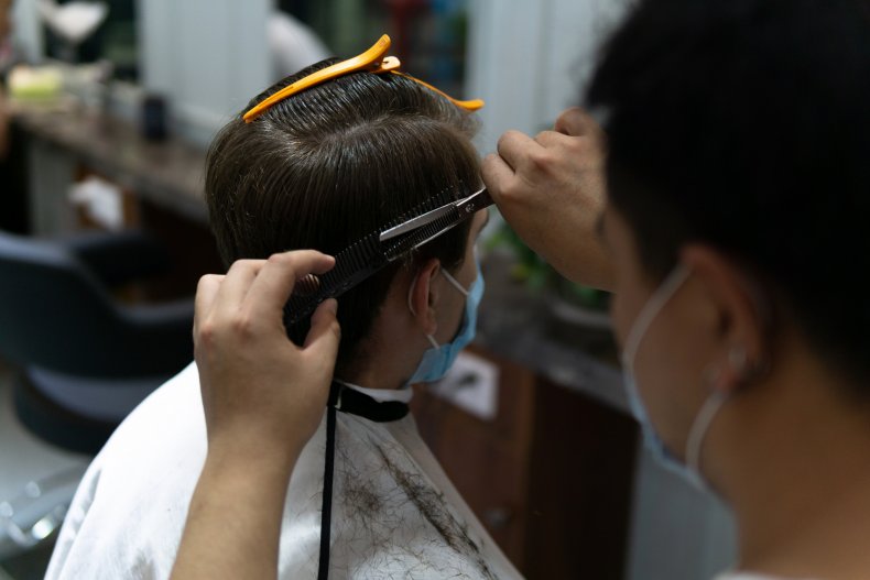Barber and client with masks