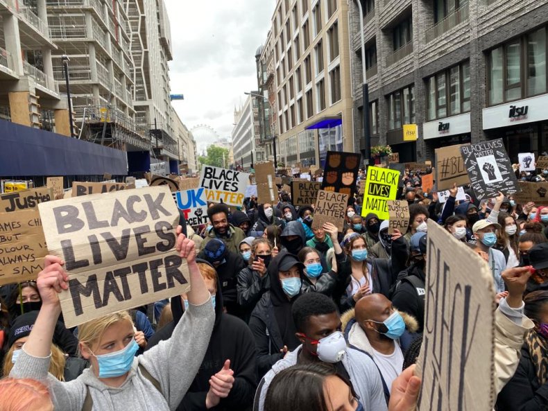 Protesters hold up signs in London