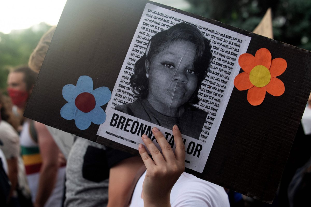 A demonstrator holds a sign with the 