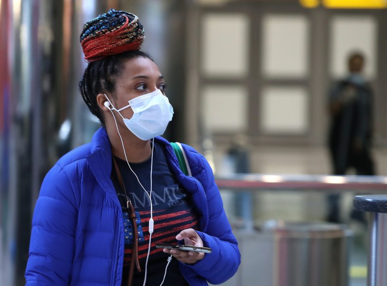 A traveler wears a mask in airport A traveler wears a mask in airport