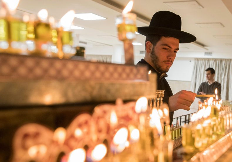 Orthodox Jew lighting candles during Chanukah