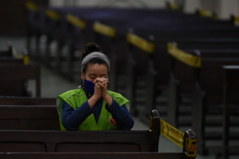 Cristian wears mask while praying