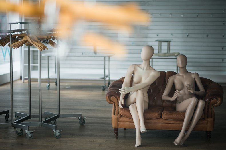 Mannequins and empty clothes rails in store