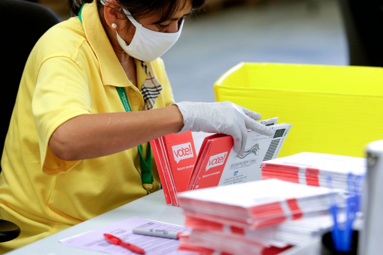 Mail-in ballots An election worker opens envelopes