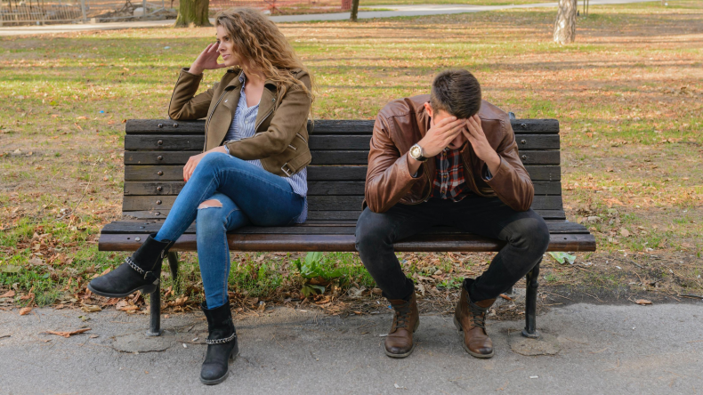 Couple fighting on park bench
