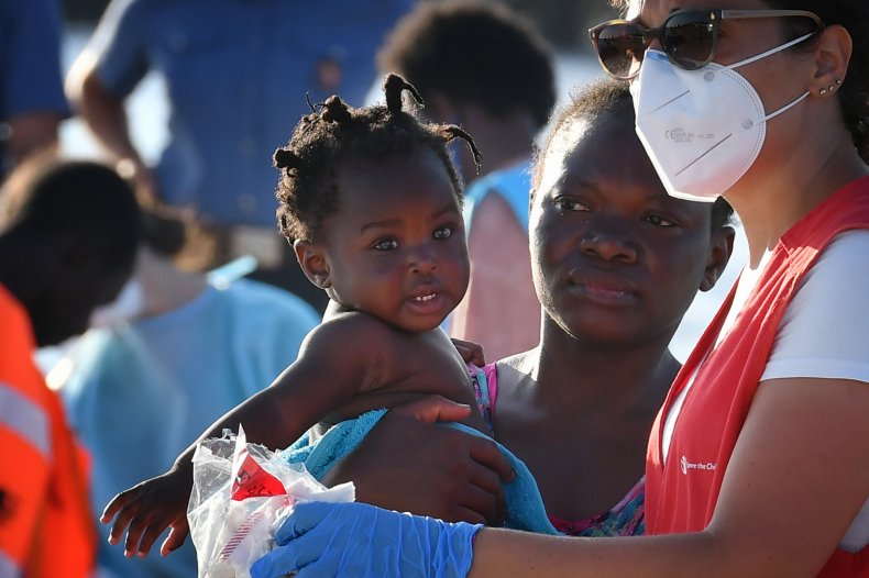 Migrant from Libya and her child