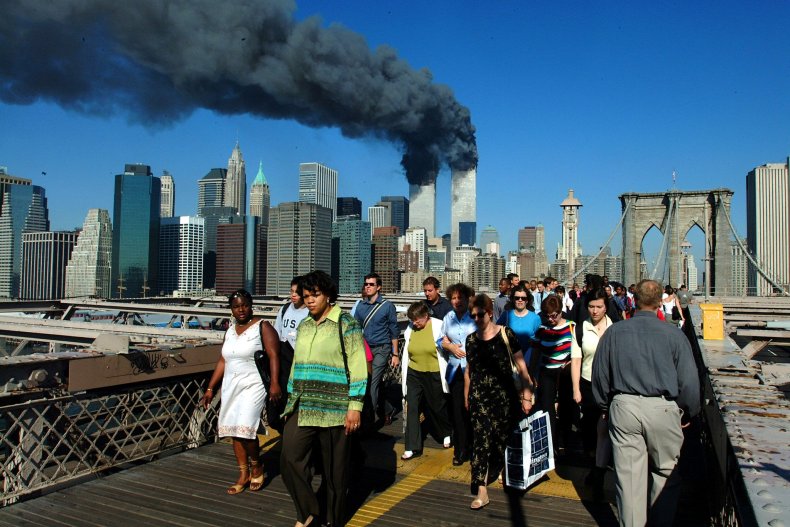 Pedestrians walk across the Brooklyn Bridge