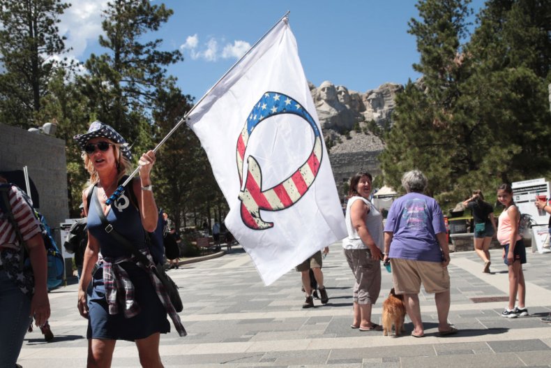Donald Trump supporter holding a QAnon Flag