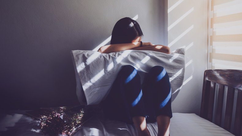 Woman hugs pillow