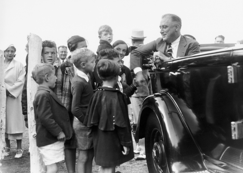 1934: President Roosevelt in car greeted by son Elliott